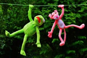 Peluches rebelles : Kermit et Panthère Rose faisant des bêtises